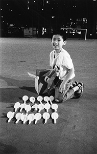 Boy with candles at the June 4th memorial rally, Victoria Park, 4 June 2002