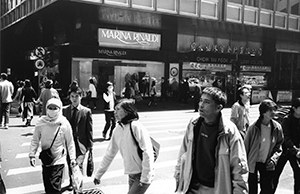 People wearing masks as protection against the 'atypical pneumonia' (later to be named SARS), Queen's Road Central, 25 March 2003