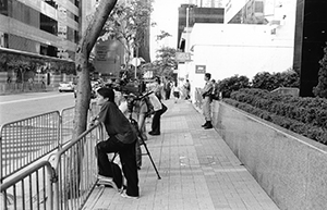 Reporters, police and crowd control barriers opposite the Grand Hyatt Hotel, Wanchai, 30 June 2003