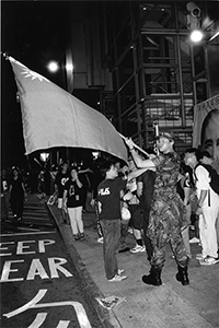 Protester waving a Taiwanese flag during a pro-democracy march from Causeway Bay to Central, 1 July 2003