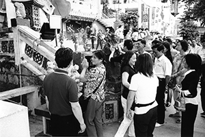 People touching a statue for luck, near Repulse Bay beach, 20 May 2004