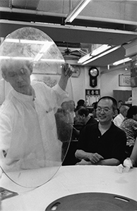 Waiter setting up a glass turntable, Lin Heung Tea House, Wellington Street, Hong Kong Island, 26 June 2004