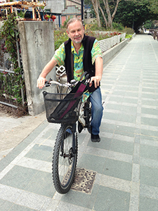 Musician Roy Stark cycling on Tung Wan Tau Road, Mui Wo, Lantau, 16 March 2014