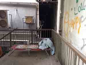 A street-sleeper's bed on steps in a back alley, Sheung Wan, Hong Kong Island, 26 July 2014