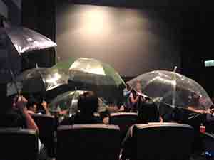 Audience holding up umbrellas as a political gesture after a film showing at Broadway Cinema, Metroplaza, Kwai Chung, 12 November 2014