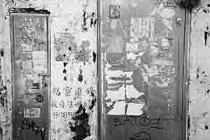 Graffiti and torn posters in an alleyway, Kowloon, 27 November 2016