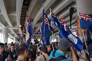 Colonial era Hong Kong flags on display during the annual pro-democracy march from Victoria Park, Canal Road West, Wanchai, 1 July 2017