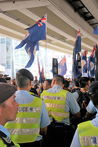 Pro-independence group closely followed by police, on the annual pro-democracy march, Wanchai, 1 July 2017