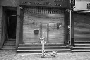 Airport trolley outside a closed shop, Sheung Wan, 15 February 2018