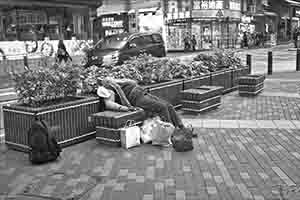 Person resting on a bench, Sheung Wan Cultural Square, 15 February 2018