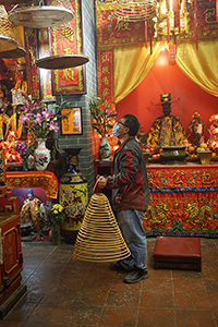 Man holding an incense coil in a temple, Kowloon, 16 February 2018