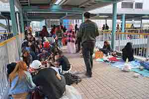 Foreign domestic helpers gather on a footbridge on their day off, Mongkok, 16 February 2018
