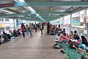 Foreign domestic helpers gather on a footbridge on their day off, Mongkok, 16 February 2018