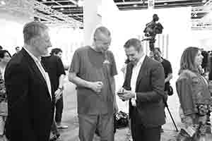 Wolfgang Tillmans (middle) and Jeff Koons (right) at Art Basel Hong Kong, Convention and Exhibition Centre,  Wanchai, 27 March 2018