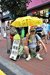 Protester with umbrella, Causeway Bay, 1 July 2018