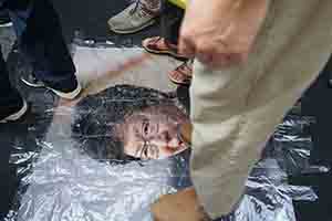 Stepping on a portrait of Carrie Lam during the annual pro-democracy march, Hennessy Road, Wanchai, 1 July 2018