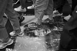 Stepping on a portrait of Carrie Lam during the annual pro-democracy march, Hennessy Road, Wanchai, 1 July 2018