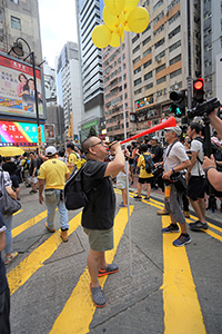 Participant with vuvuzela in the annual pro-democracy march, Causeway Bay, 1 July 2018