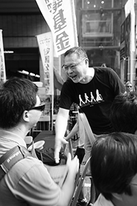 Benny Tai, interacting with a participant in the annual pro-democracy march, Hennessy Road, Wanchai, 1 July 2018