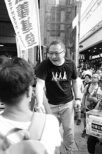 Benny Tai, interacting with a participant in the annual pro-democracy march, Hennessy Road, Wanchai, 1 July 2018