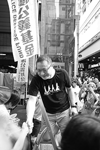 Benny Tai, interacting with a participant in the annual pro-democracy march, Hennessy Road, Wanchai, 1 July 2018