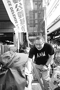 Benny Tai, interacting with a participant in the annual pro-democracy march, Hennessy Road, Wanchai, 1 July 2018