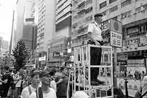 Policeman on crowd control duty during the annual pro-democracy march, Yee Wo Street, Causeway Bay, 1 July 2018