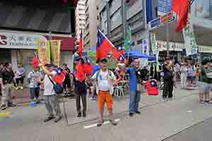 Participants with Taiwanese flags in the annual pro-democracy march, Hennessy Road, 1 July 2018