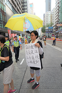 Participant in the annual pro-democracy march, Hennessy Road, Wanchai, 1 July 2018