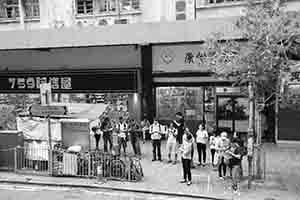 People waiting at a bus stop, Sai Ying Pun, 9 October 2018