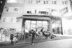 People sit outside a restaurant and bar, Peel Street, Central, 4 October 2018