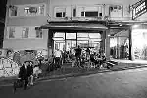 People sit outside a restaurant and bar, Peel Street, Central, 4 October 2018