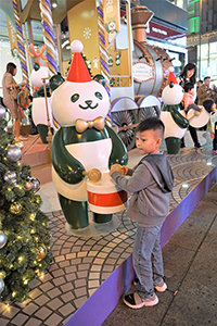 Child and Christmas decorations in front of iSQUARE, Kowloon, 26 December 2018