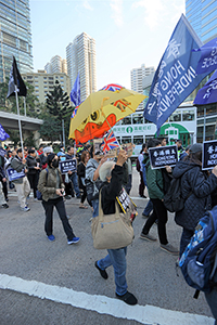 A woman holding a yellow umbrella, New Year's Day protest march, Queensway, Admiralty, 1 January 2019