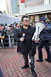 A man holding an electric megaphone, Queensway, Admiralty, 1 January 2019
