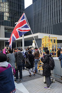 A woman holding a British flag at the New Year's Day protest march, Central Government Offices Complex, Admiralty, 1 January 2019