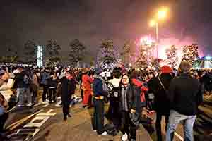 A women taking a selfie, with fireworks visible behind, Lung Wo Road, Central, 1 January 2019