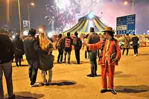 A man taking a selfie, with fireworks visible behind, Lung Wo Road, Central, 1 January 2019