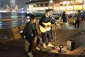 Busking after midnight at the Central Ferry Piers, 1 January 2019