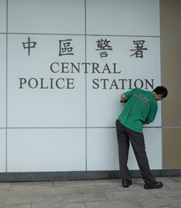 Worker cleaning graffiti from the wall of Central Police Station, Chung Kong Road, Sheung Wan, 22 July 2019