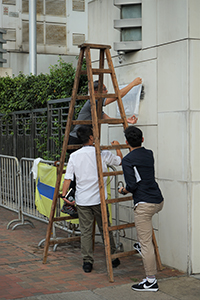 Police investigating the entrance of the Liaison Office of the Central People's Government, after vandalism in a protest, Sai Ying Pun, 22 July 2019