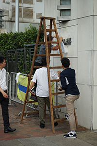 Police investigating the entrance of the Liaison Office of the Central People's Government, after vandalism in a protest, Sai Ying Pun, 22 July 2019