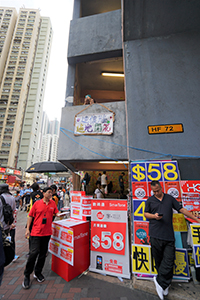 Internet service sales booth in front of a Lennon Wall, Tai On Building, Sai Wan Ho, 12 July 2019
