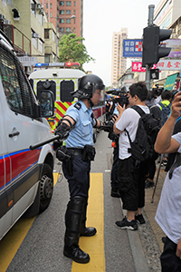 Police separating a crowd from police vehicles, 'Reclaim Sheung Shui' protest against parallel traders from China, 13 July 2019