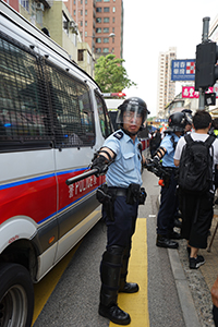 Police separating a crowd from police vehicles, 'Reclaim Sheung Shui' protest against parallel traders from China, 13 July 2019