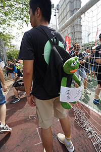 Man with Pepe the Frog on his backpack, in a crowd gathering near the Che Kung Temple for an anti-extradition bill march to Sha Tin, 14 July 2019