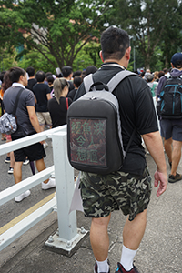 Digital protest sign on a man's backpack, anti-extradition bill march to Sha Tin, 14 July 2019