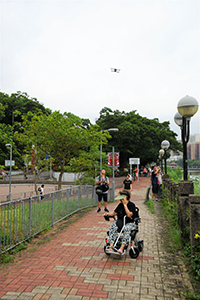 Man with a drone and woman in a wheelchair, Sha Tin, 14 July 2019