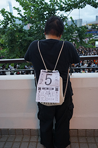 Protester with a sign on his backpack, on a balcony above City Hall Memorial Garden, Central, 2 August 2019