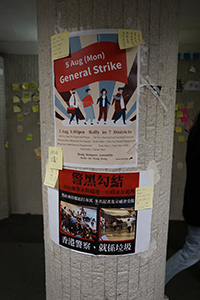 Posters and stickers on a pillar, in the tunnel to Edinburgh Place, Central, 2 August 2019